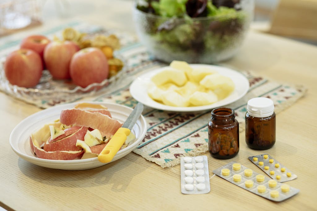 A wholesome scene showcasing apples, salad, and various supplements for a balanced diet.